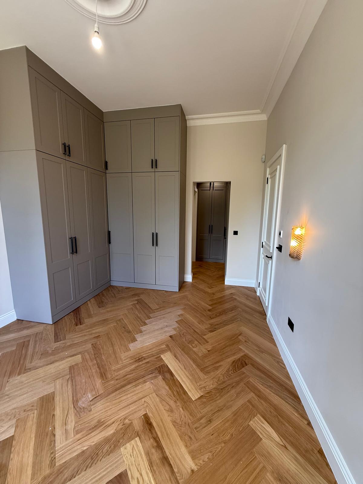 Herringbone flooring with fitted wardrobes