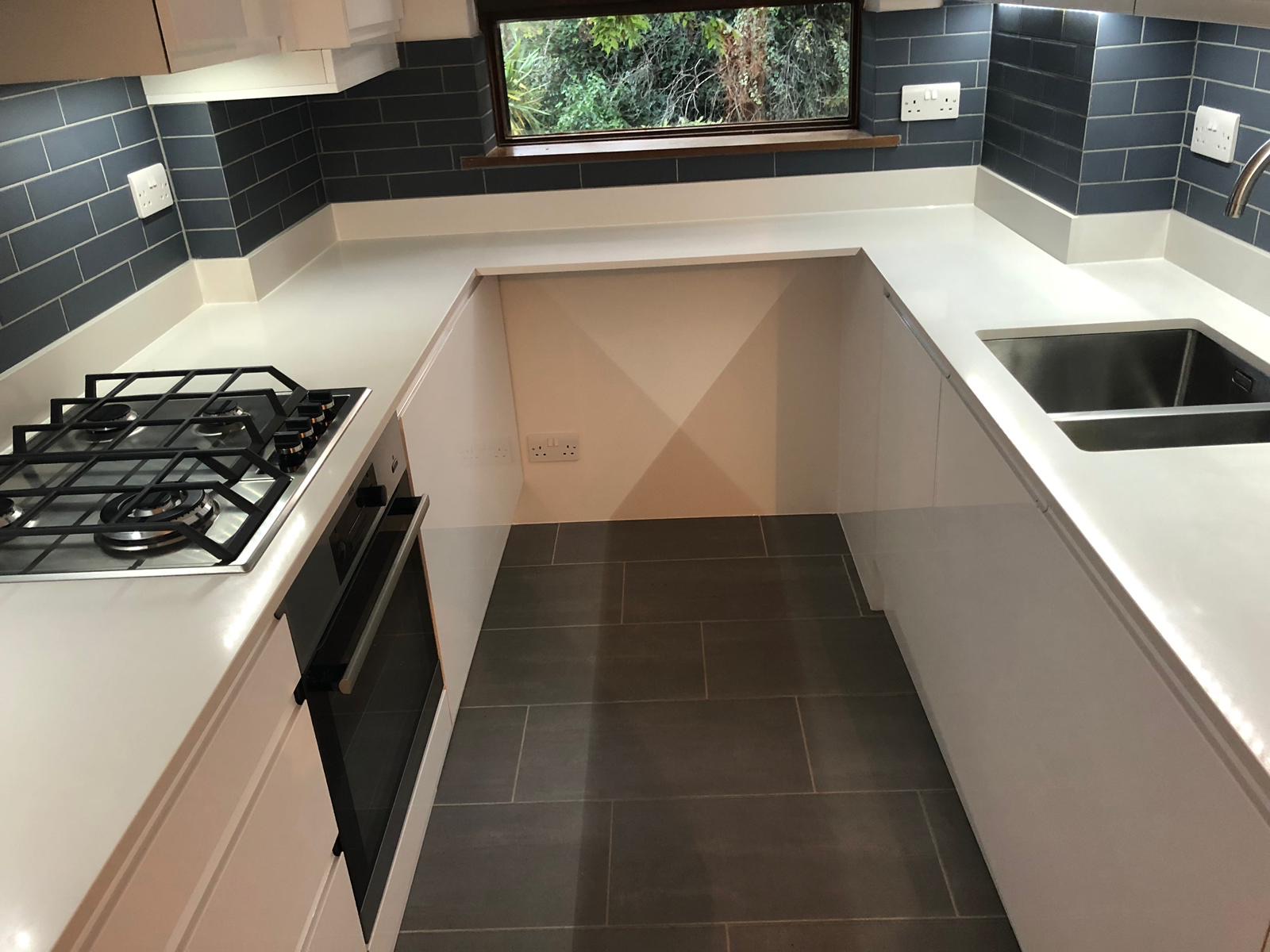 Modern kitchen with blue subway tiles